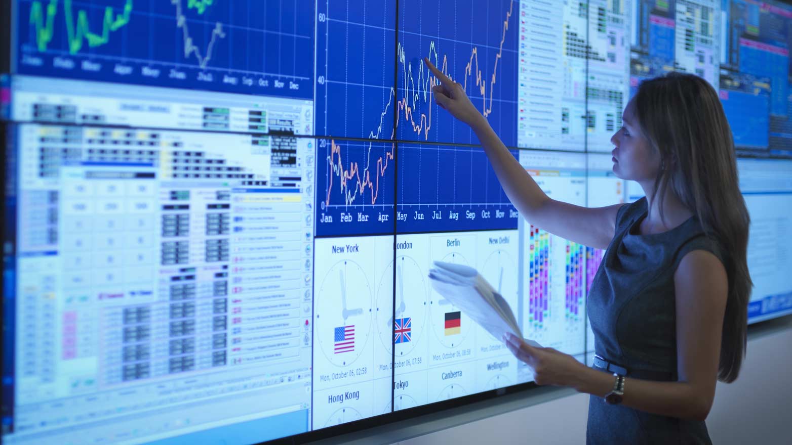women interacting with statistical graphs on a digital display during a presentation